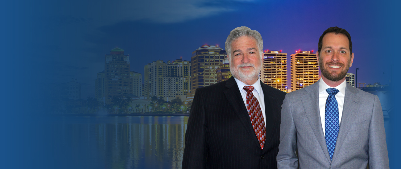 Attorneys in front of West Palm Beach, Florida skyline and city lights as night falls